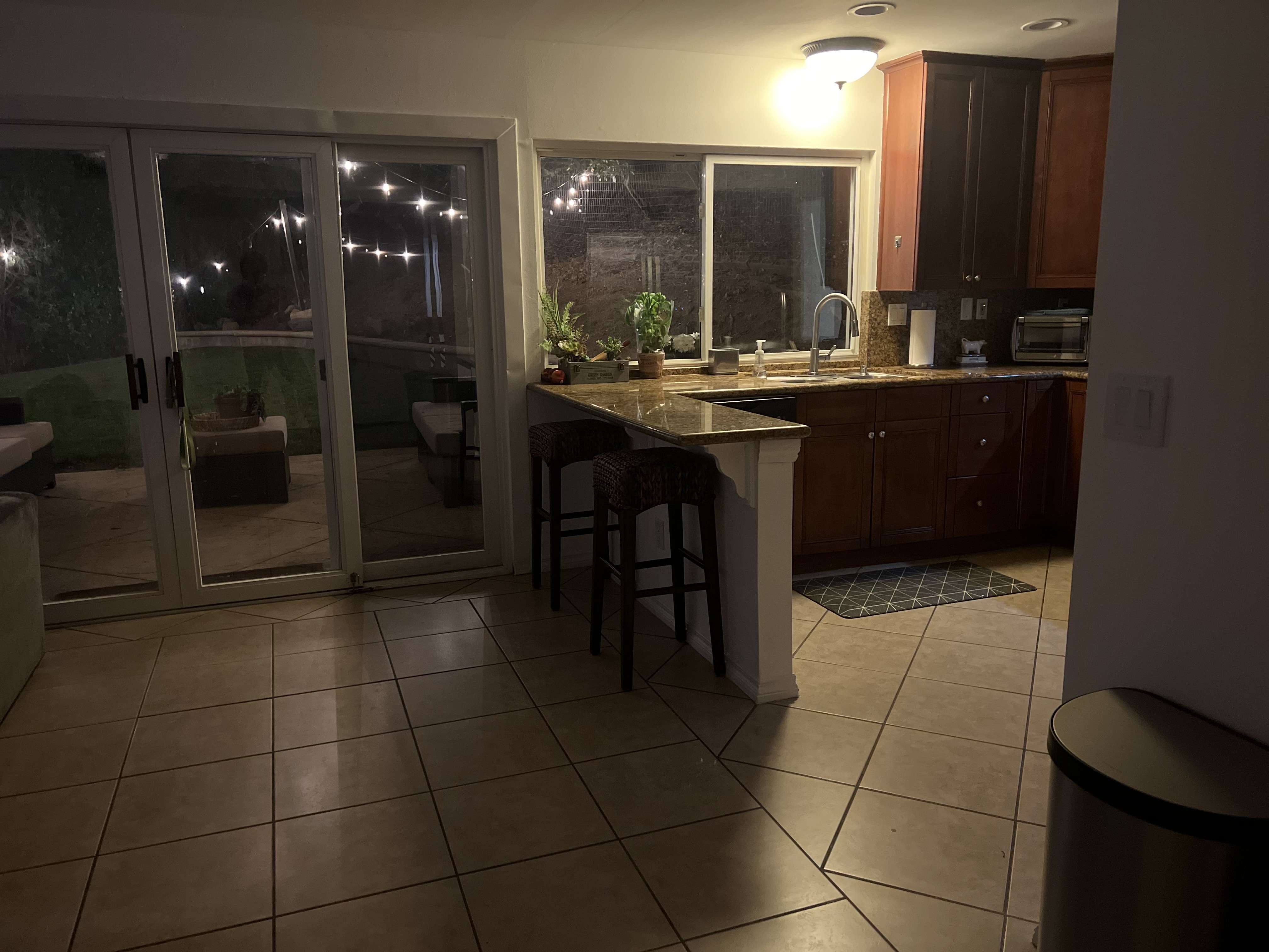 Kitchen opening to the lit patio